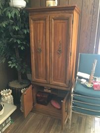 Vintage sewing cabinet; opens and sewing machine drops down.  Plenty of storage for sewing suppliles.