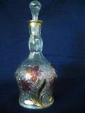 BEAUTIFUL VINTAGE DECANTER - Clear pressed glass bottom with floral design of pink flowers and gold stems. Hand blown glass stopper.