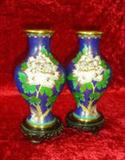 PAIR OF ASIAN METAL HAND PAINTED VASES ON WOOD PEDESTALS - Purple base with pink and yellow flowers & green stems. Trimmed in gold.