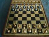 CHESS SET IN CARRYING CASE - Gold and black playing board with Gold and silver Chess pcs. Simulated Ostrich carrying case.