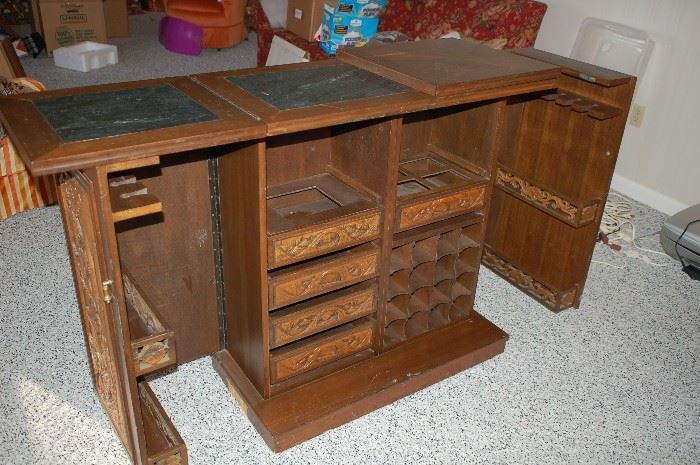 Picture of bar opened with drawers, wine rack displayed