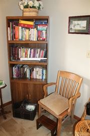Bookcase with books, chair, baskets