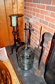 Large glass bottle, iron candleholders, fireplace tools