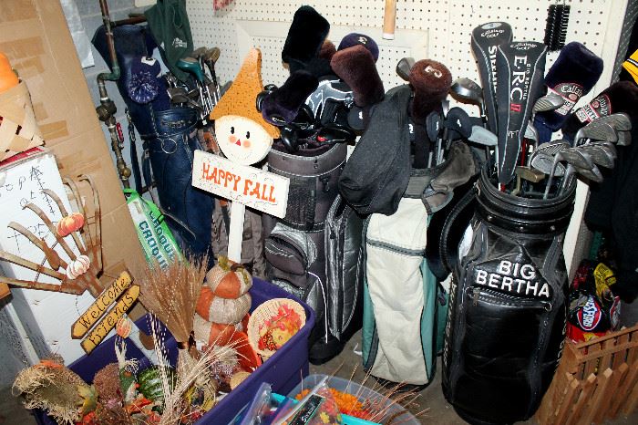 Several sets of golf clubs, fall decor