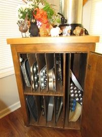Butcher block cabinet with dividers for pan storage.