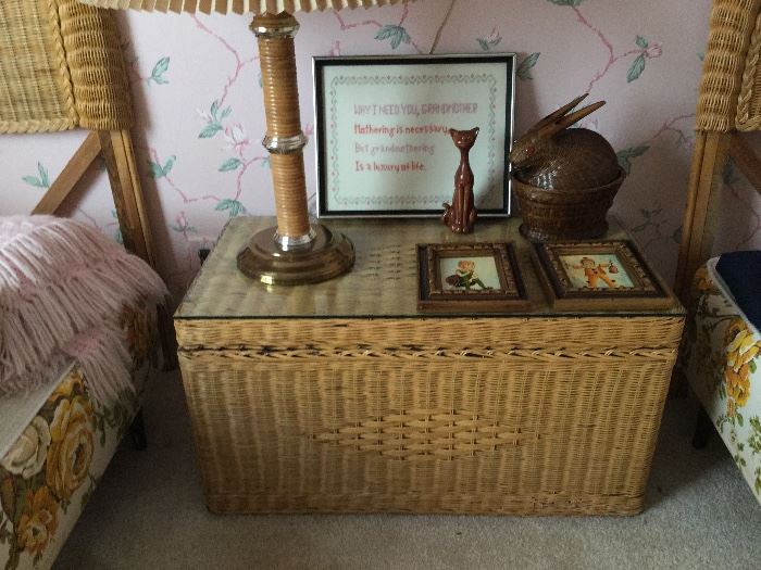 Wicker trunk used as night table for both wicker beds, glass top