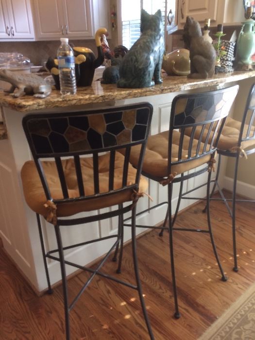 a trio of wrought iron bar stools 