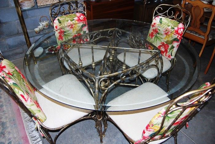 Wrought Iron Table with 4 Chairs and Glass Top. 