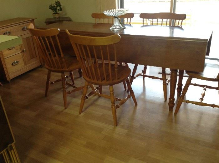 6 solid winsor style chairs . Drop leaf maple harvest table.