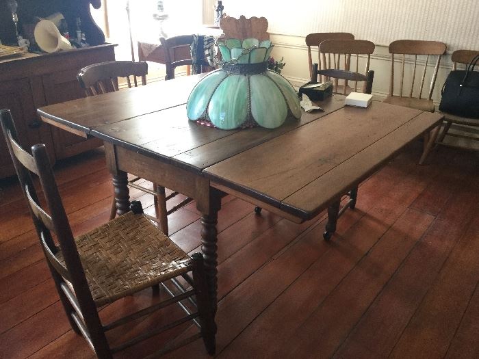 Antique dining table with cane chairs