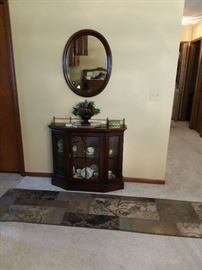 Short Display Cabinet; Large Oval Mirror and Long Area Rug