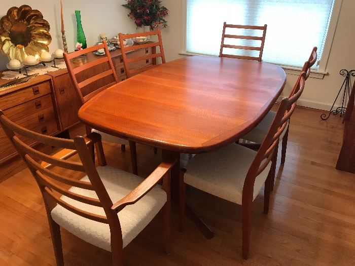 
Very nice Danish mid century modern dining room set by Dyrlund. Teak wood in great condition with very minor signs of use and wear. Set includes
- table with 6 chairs
-2 credenzas 
-2 floating cabinets/shelves
-server/bar

Will separate set.

Table comes with original tables pads for protection. White cushions are all in excellent condition with no rips or stains. 