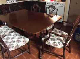 Dining room table & 6 chairs(2 are captains) has one leaf and pads for all
