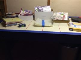 Scrapbooking stuff on air hockey table