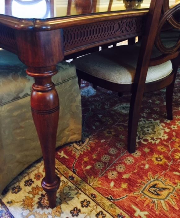 Detail of dining table and oriental rug