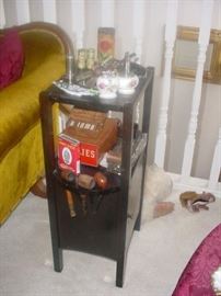 Old smoking stand filled with old smoking accessories inside and on top