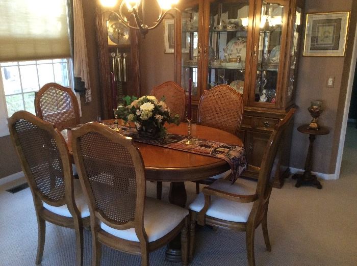 DINING ROOM TABLE WITH 2 LEAVES AND 6 CHAIRS ALSO THE CHINA CABINET IN THE BACK THAT IS FULL OF SMALLS