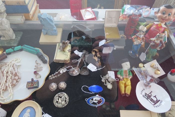 Assorted jewelry,60's sculptures and collectable toys.