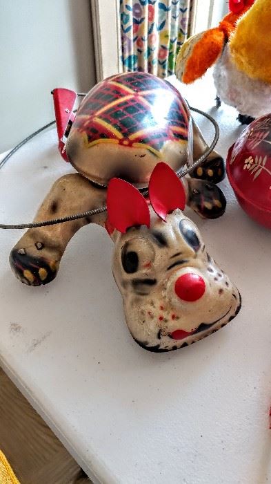 Vintage metal dog toy with handle that makes his feet move