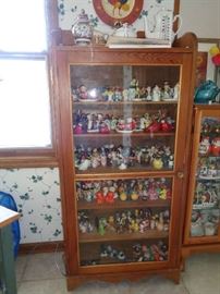 curio cabinet filled w/salt & peppers, some vintage