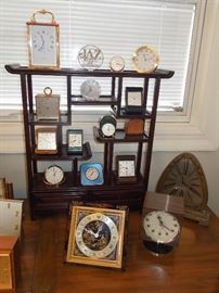 Superb collection of 8-day Swiss and American desk, shelf, carriage and travel clocks including Imhof, Angelus, Looping, Tiffany & Co., Chelsea and Waltham.  Rare 1960s double dial ("partner's") desk clock retailed by Georg Jensen.  Stunning diminutive antique Chinese rosewood display cabinet with three drawers.