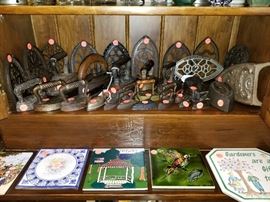 Remarkable collection of antique irons and stands.