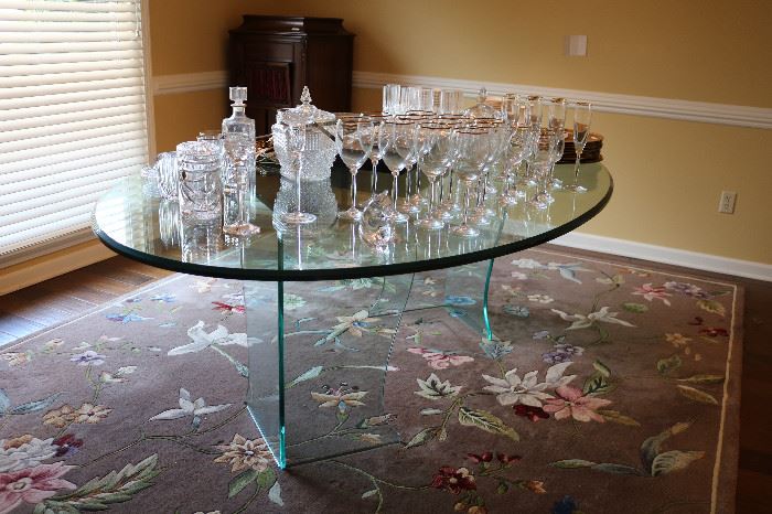 Love this glass table.  Any chairs would compliment it. The rug is lovely also.