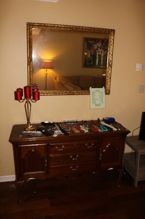 Small amount of jewelry. Big mirror. Side chest like a buffet. Or stand for flat screen TV