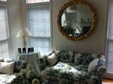 floral loveseat and huge gold framed mirror
