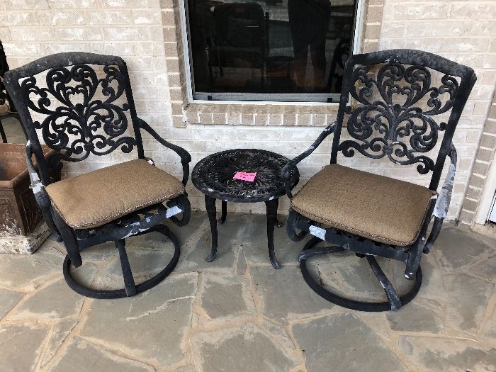 Pair of scrolled wrought iron chairs and table