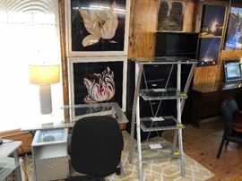 Another glass and chrome desk with a book shelf and file cabinet.