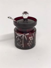 Cranberry cut to clear lidded jar.