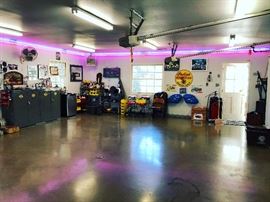 Harley Davidson garage cabinets - vintage motorcycle and antique car art, fans. neon, tools - Vintage Lube Machine, Vintage Harley Doormat, Vintage Indian Parts, small refridgerator, loads of car and motorcycle products, Neon Jaguar Parts sign - authentic, rolling carts, wall fans ,