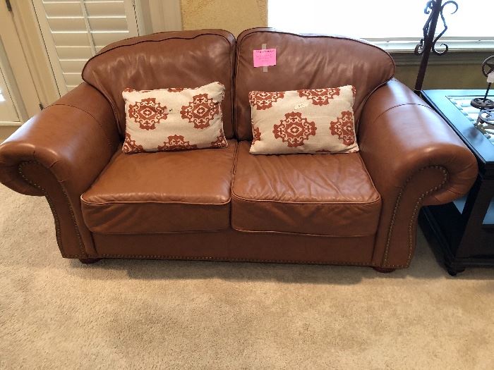 Matching leather loveseat with nailhead trim