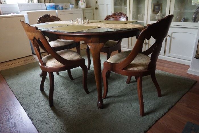 Mahogany Table with leaves and 8 chairs with rose carvings