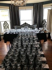 Stemware, st the end of the table is a signed Hicks loveseat and a pair of Baltimore Hall Chairs all three pieces from the home of Carolyn Martin Carlie’s Maternal great grandmother