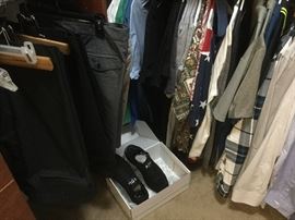 Closet full of men's clothing.