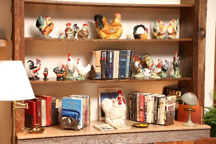 Collection of rooster pottery and more books.