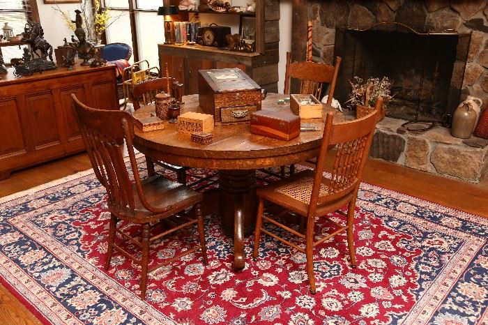 Round oak table and assorted chairs.