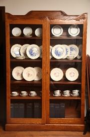 Very nice oak bookcase, filled with sets of china.
