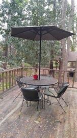Wrought iron patio set five chairs and umbrella