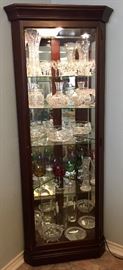 Corner Curio Cabinet.  Lighted, glass shelves, mirrored back.  Lovely style that will fit into any décor.