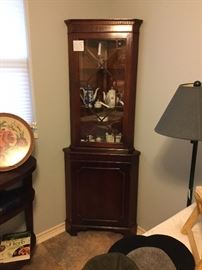 Antique Chippendale style  mahogany corner cabinet, dental molding pediment. Framed glass stores with geometric fretwork. Three top shelves, to bottom cabinet shelves. Top and bottom lock.