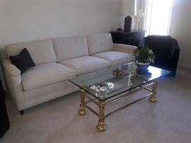 formal sofa with brass and glass coffee table