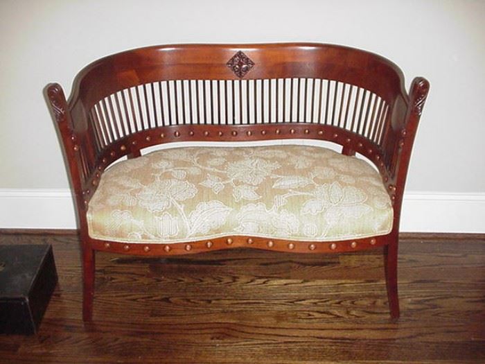 Sweet upholstered loveseat with curved, spindle back, 19th century