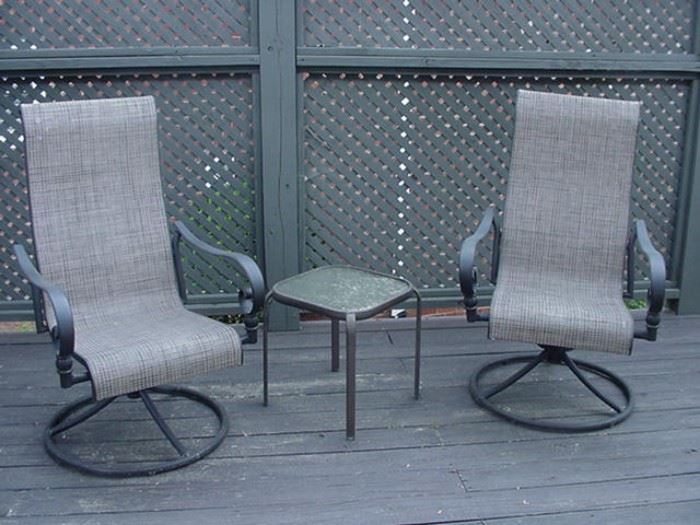 Two  swivel base patio chairs and table--others around table