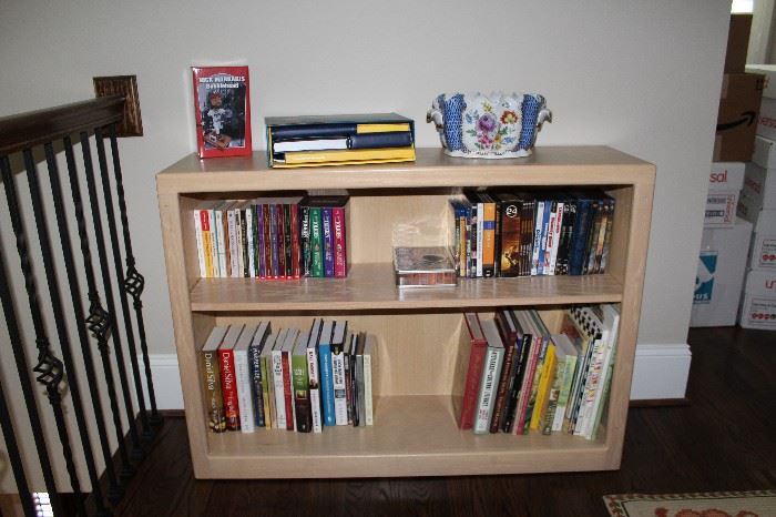 Bookcase with many paper and hardback books--also DVDs