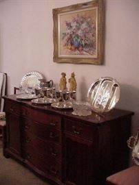 Buffet with well and tree platters, revere bowls, silverplated goblets, cut glass bowl, and silverplated trays