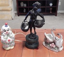 Lefton clown light, Capodimonte swans, and vintage bronze on a marble base