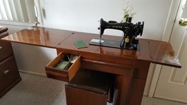 1950's sewing machine, original cabinet, stool with storage under seating pad, accessories, original instruction book